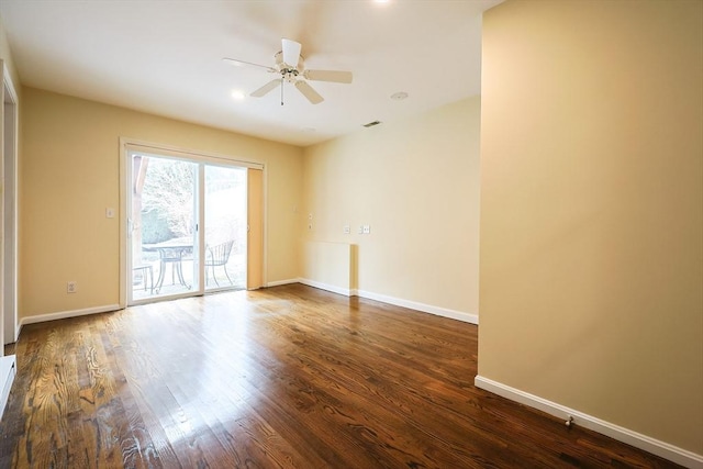 unfurnished room with dark hardwood / wood-style floors and ceiling fan