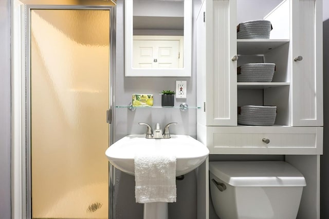 bathroom with an enclosed shower and toilet