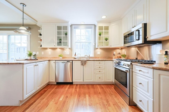 kitchen featuring pendant lighting, white cabinetry, and stainless steel appliances