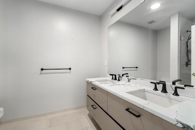 full bathroom featuring double vanity, toilet, visible vents, and a sink