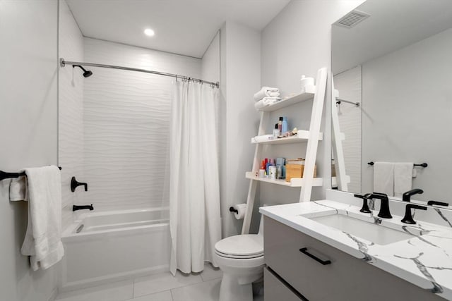 bathroom featuring vanity, visible vents, shower / tub combo, tile patterned floors, and toilet