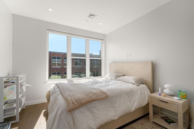 bedroom featuring recessed lighting, visible vents, baseboards, and wood finished floors