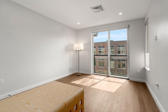 unfurnished bedroom featuring recessed lighting, visible vents, baseboards, and wood finished floors