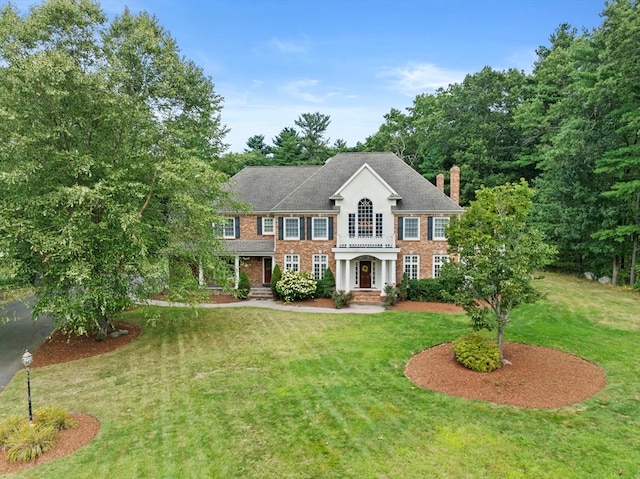 colonial-style house with a front yard