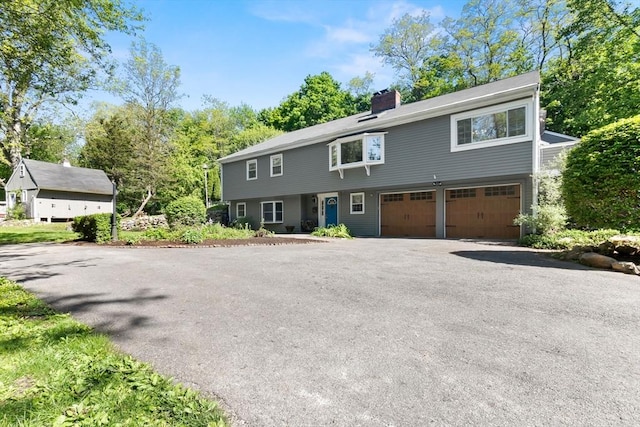 17 Topsfield Rd, Wenham, MA 01984 - view of front of property with a garage, a chimney, and driveway