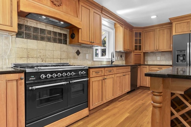 17 Topsfield Rd, Wenham, MA 01984 - kitchen with black appliances, a sink, custom range hood, light wood-type flooring, and backsplash