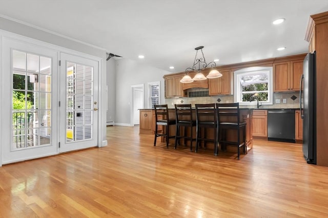 17 Topsfield Rd, Wenham, MA 01984 - kitchen with dishwashing machine, freestanding refrigerator, backsplash, light wood finished floors, and a kitchen bar