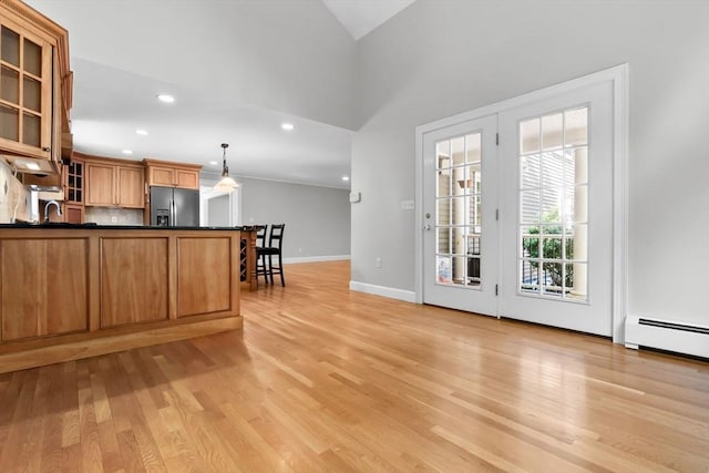 17 Topsfield Rd, Wenham, MA 01984 - kitchen featuring refrigerator with ice dispenser, dark countertops, light wood-type flooring, glass insert cabinets, and a baseboard radiator