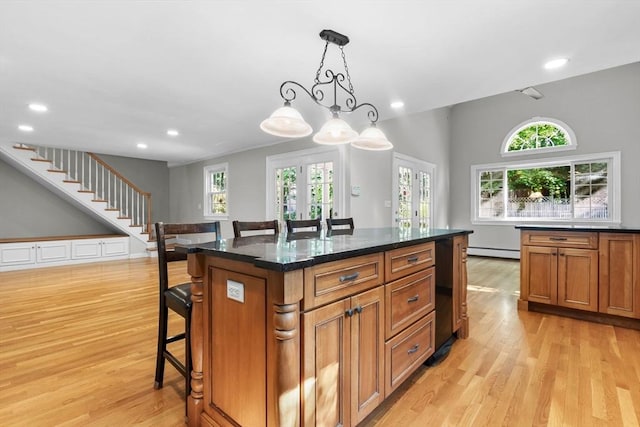 17 Topsfield Rd, Wenham, MA 01984 - kitchen with light wood-style floors, baseboard heating, a kitchen bar, recessed lighting, and brown cabinetry