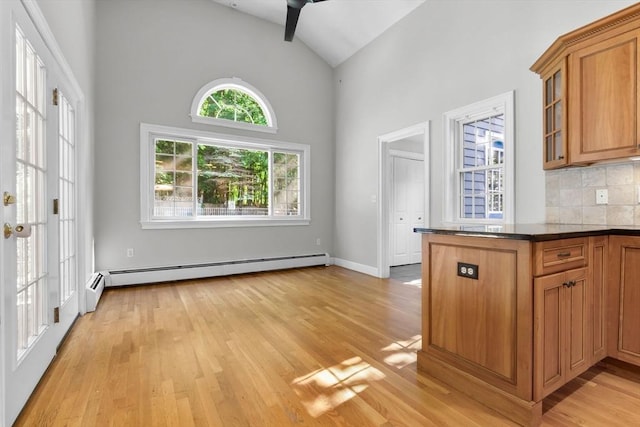 17 Topsfield Rd, Wenham, MA 01984 - kitchen with brown cabinets, light wood-style flooring, a baseboard radiator, high vaulted ceiling, and glass insert cabinets