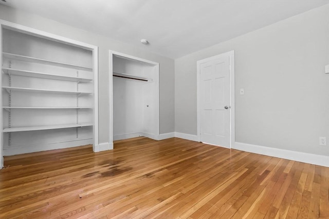 17 Topsfield Rd, Wenham, MA 01984 - unfurnished bedroom featuring light wood-style floors, baseboards, and multiple closets