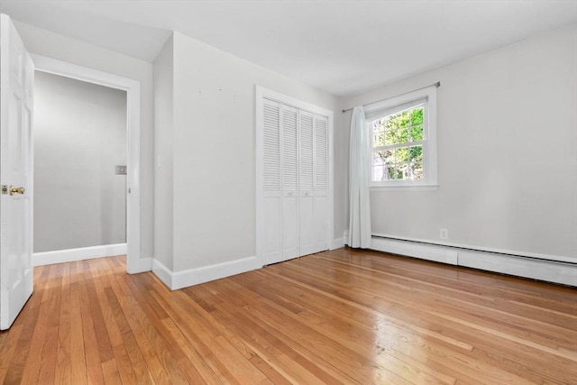 17 Topsfield Rd, Wenham, MA 01984 - unfurnished bedroom with light wood-type flooring, baseboards, baseboard heating, and a closet