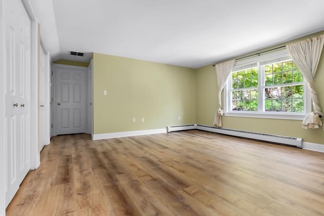 17 Topsfield Rd, Wenham, MA 01984 - empty room with light wood-style floors, a baseboard heating unit, and baseboards
