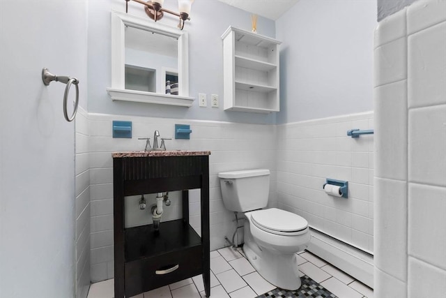 17 Topsfield Rd, Wenham, MA 01984 - bathroom with toilet, a wainscoted wall, tile patterned floors, tile walls, and a baseboard heating unit
