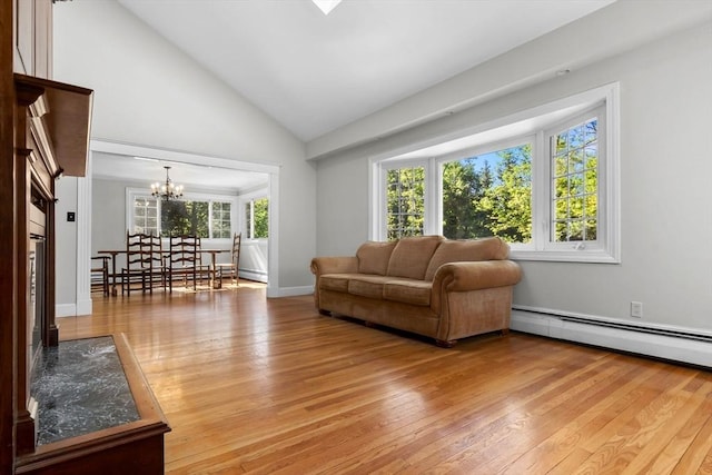 17 Topsfield Rd, Wenham, MA 01984 - living area with a baseboard heating unit, a chandelier, light wood-style flooring, and high vaulted ceiling