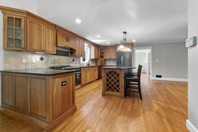 17 Topsfield Rd, Wenham, MA 01984 - kitchen with double oven range, stainless steel refrigerator with ice dispenser, dark countertops, light wood finished floors, and recessed lighting