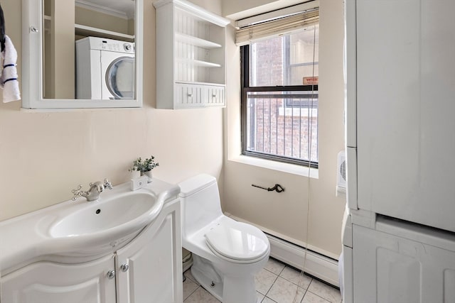 bathroom with vanity, tile patterned flooring, crown molding, toilet, and a baseboard heating unit