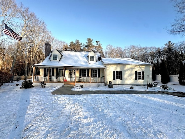 cape cod house featuring covered porch