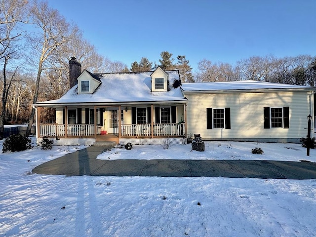 cape cod home featuring a porch