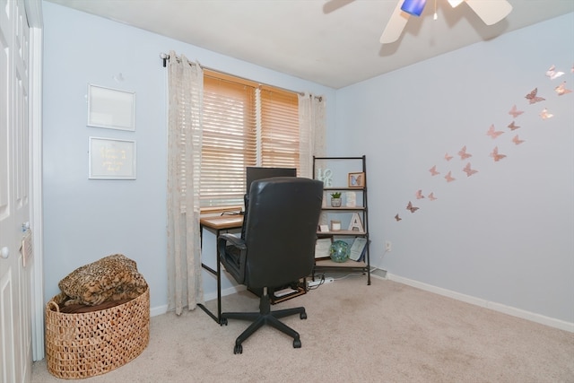 carpeted office space featuring ceiling fan