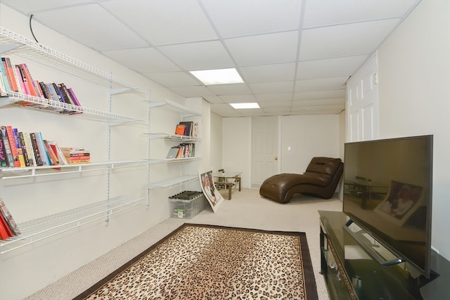 interior space with a paneled ceiling and carpet floors