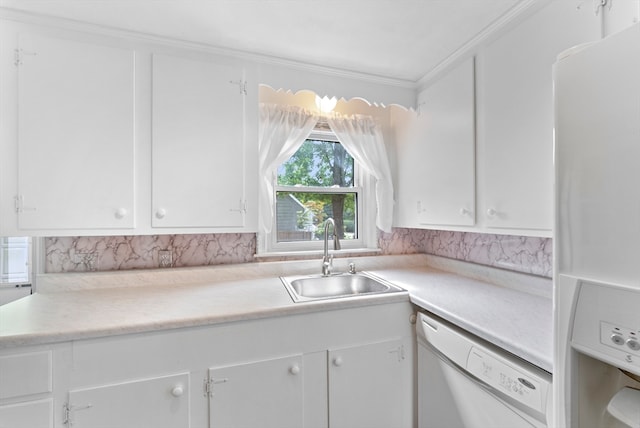 kitchen featuring sink, white appliances, and white cabinetry