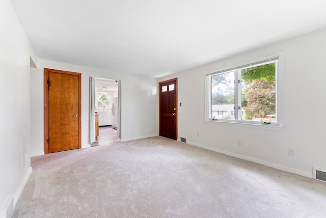 unfurnished bedroom featuring light carpet