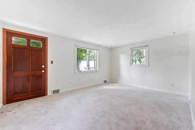 view of carpeted foyer entrance