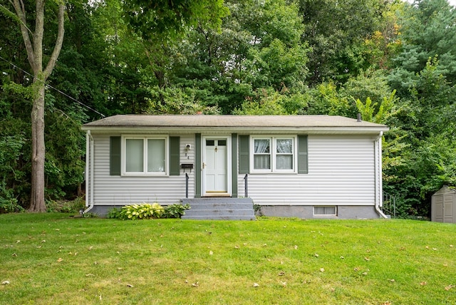 view of front of house featuring a storage shed and a front yard