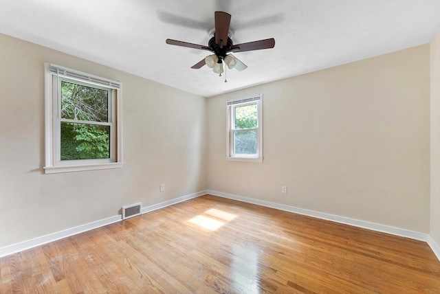 unfurnished room featuring light wood-type flooring and ceiling fan