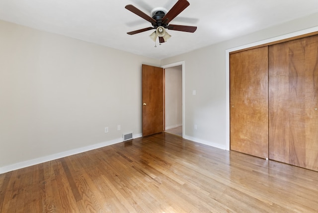 unfurnished bedroom featuring ceiling fan, a closet, and light hardwood / wood-style floors