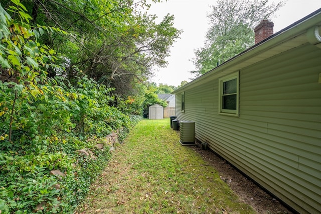 view of yard with a storage shed and central AC unit