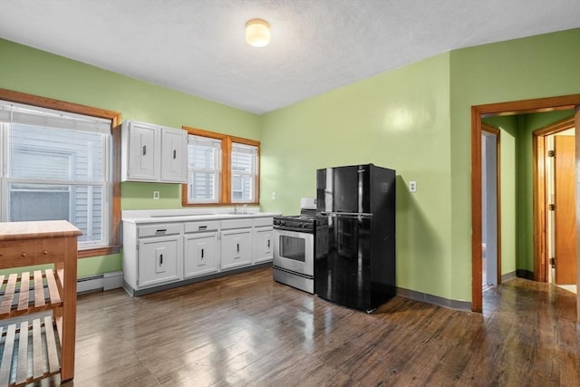 kitchen with black refrigerator, white cabinets, plenty of natural light, and stainless steel gas range