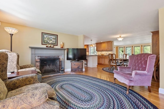 128 S Sea Ave, Yarmouth, MA 02673 - living room with light wood finished floors and a brick fireplace