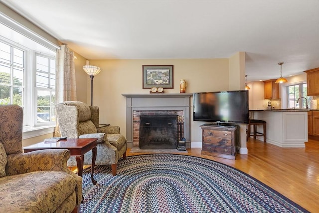 128 S Sea Ave, Yarmouth, MA 02673 - living room featuring light wood-type flooring and a fireplace