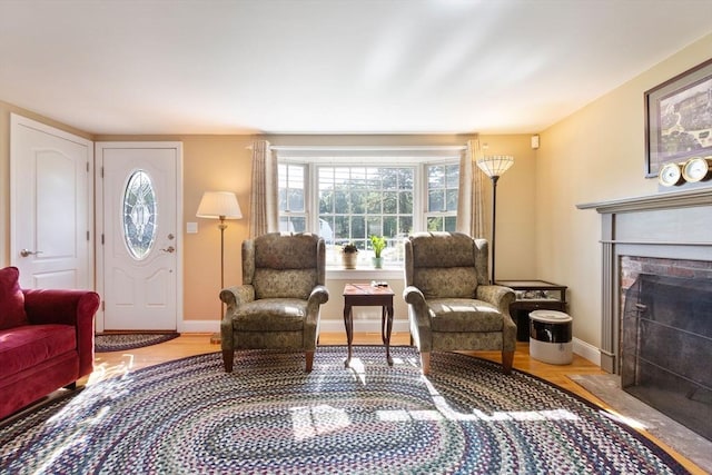 128 S Sea Ave, Yarmouth, MA 02673 - living area with wood finished floors and a fireplace with flush hearth