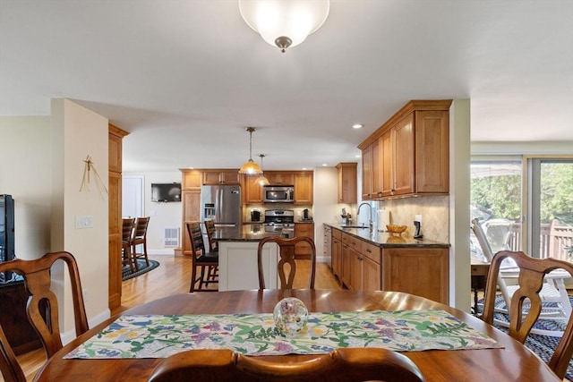 128 S Sea Ave, Yarmouth, MA 02673 - dining space featuring light wood finished floors and baseboards