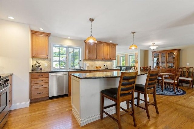 128 S Sea Ave, Yarmouth, MA 02673 - kitchen featuring stainless steel appliances, plenty of natural light, light wood-style flooring, decorative backsplash, and recessed lighting