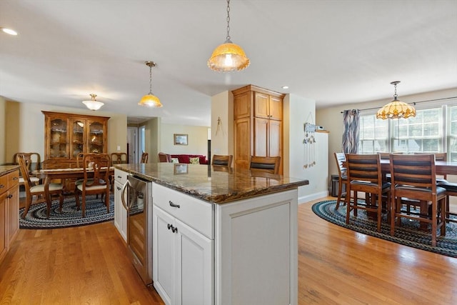 128 S Sea Ave, Yarmouth, MA 02673 - kitchen with wine cooler, light wood-style floors, recessed lighting, decorative light fixtures, and a center island