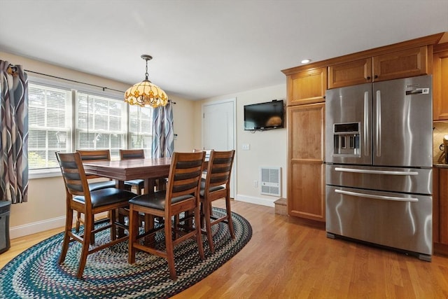 128 S Sea Ave, Yarmouth, MA 02673 - dining space with light wood-style flooring and a chandelier