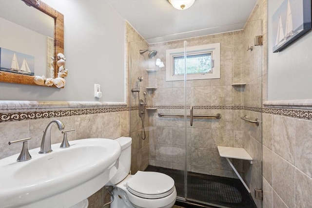 128 S Sea Ave, Yarmouth, MA 02673 - bathroom featuring tile walls, a stall shower, and wainscoting