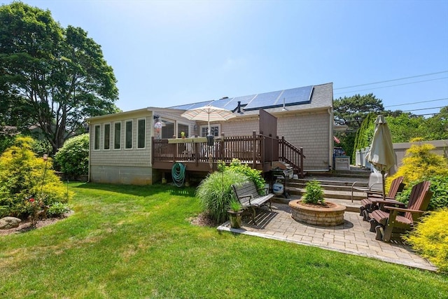 128 S Sea Ave, Yarmouth, MA 02673 - rear view of property featuring a fire pit, a deck, a yard, and a patio