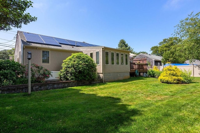 128 S Sea Ave, Yarmouth, MA 02673 - back of house with roof mounted solar panels and a yard