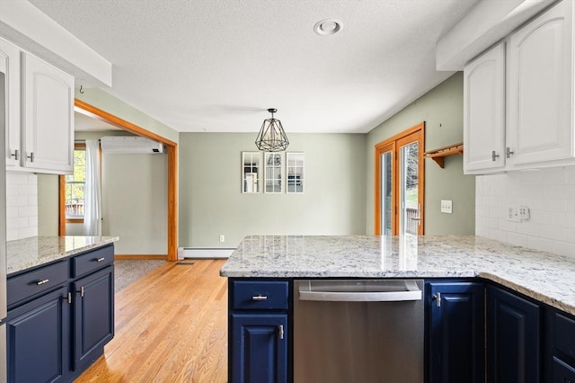kitchen featuring a peninsula, blue cabinets, dishwasher, a wall unit AC, and white cabinets