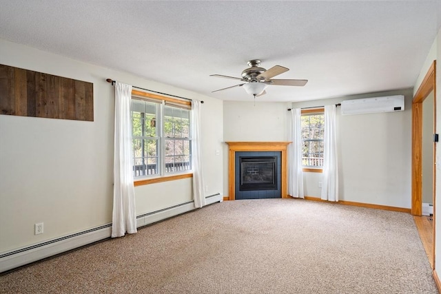 unfurnished living room featuring ceiling fan, carpet floors, a wall unit AC, and plenty of natural light