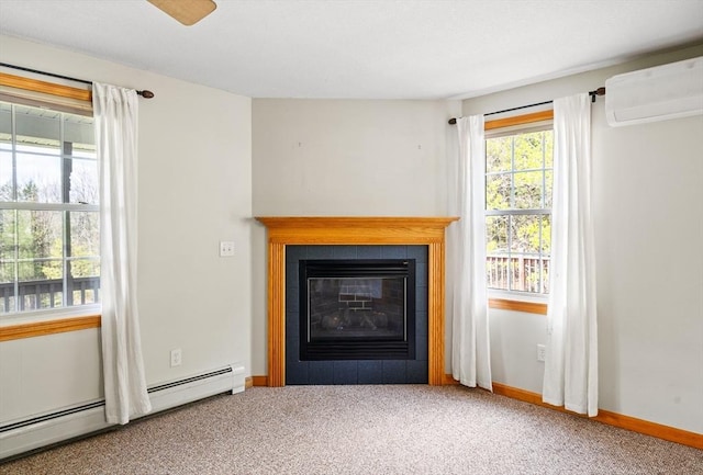 room details featuring a baseboard radiator, a wall unit AC, baseboards, a fireplace, and carpet floors