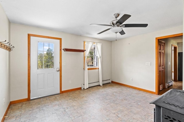 interior space with ceiling fan, baseboards, and baseboard heating