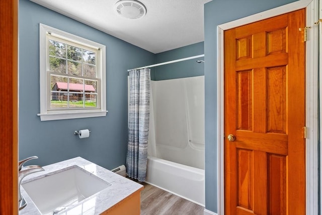 bathroom with vanity, shower / bath combo, visible vents, and wood finished floors