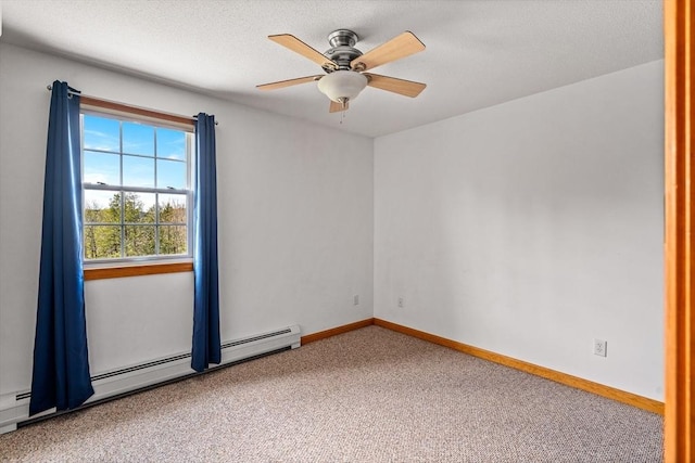 spare room with carpet, baseboards, and a ceiling fan
