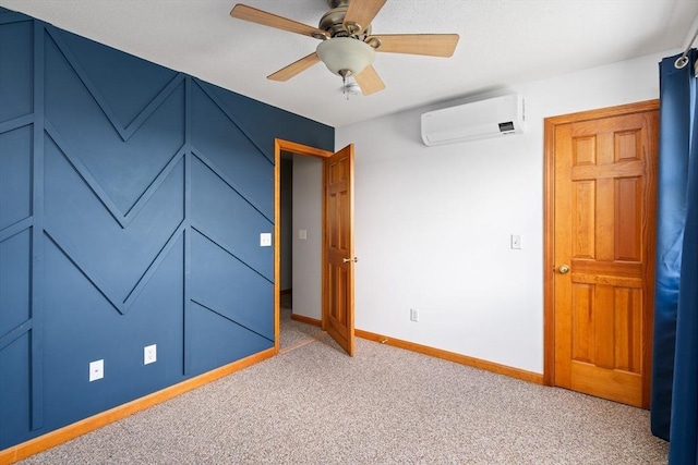 unfurnished bedroom featuring baseboards, ceiling fan, light carpet, and a wall unit AC